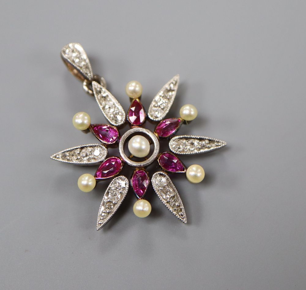 A late Victorian yellow metal, ruby, diamond and seed pearl set starburst pendant brooch, 33mm